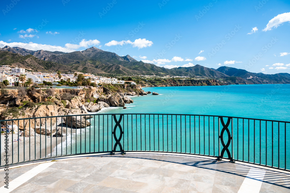 Fototapeta premium Travel destination, view on blue sea and mountains from Balcon de Europa in small Andalusian town Nerja with white houses and narrow streets on Costa del Sol, Spain