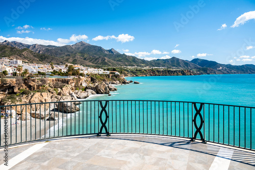 Travel destination, view on blue sea and mountains from Balcon de Europa in small Andalusian town Nerja with white houses and narrow streets on Costa del Sol, Spain photo