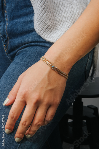 diamond bracelets on the girl s wrist with well-groomed white nail polish. jewelry models for online sale.