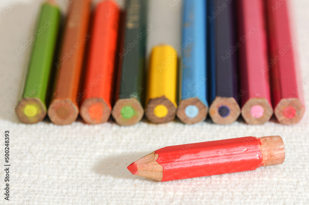 Colorful and funny arrangement of a set of pencils and ink pots.