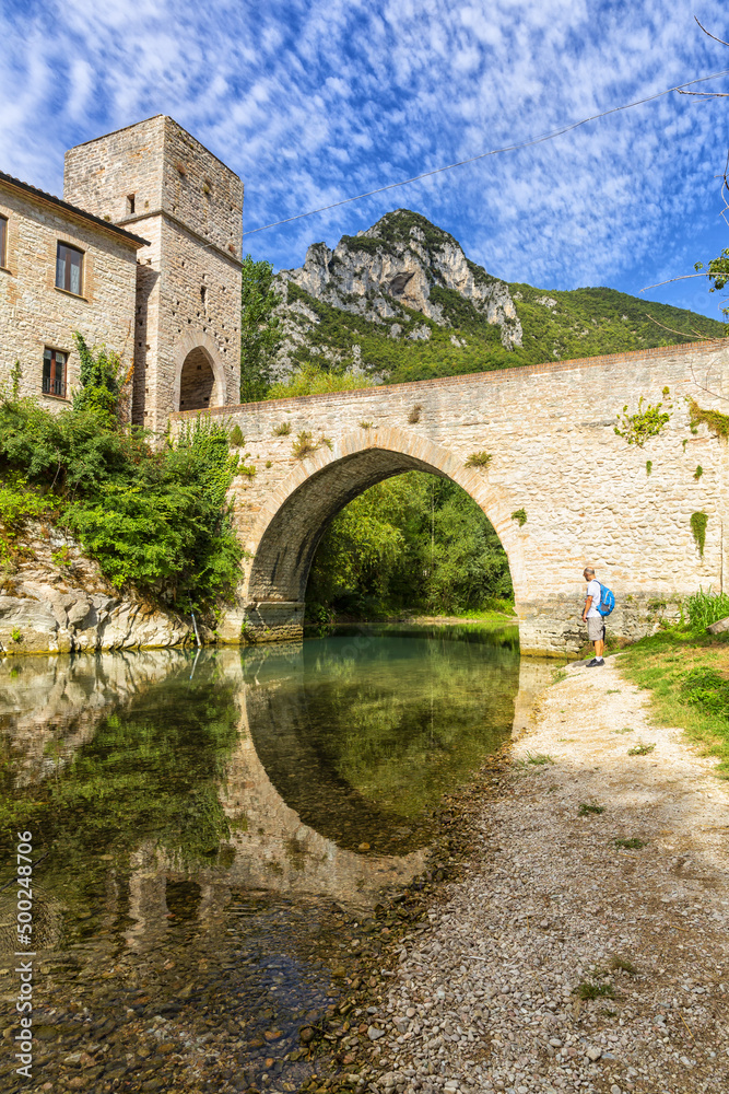 Obraz premium San Vittore alle Chiuse. Roman Catholic abbey and church. The edifice is known from the year 1011. Ponte Romano. Roman bridge over a small river. Italy.
