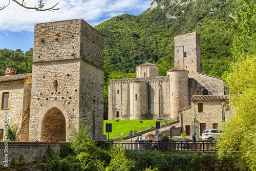 San Vittore alle Chiuse. Roman Catholic abbey and church. The edifice is known from the year 1011. Ponte Romano. Roman bridge over a small river. Italy.