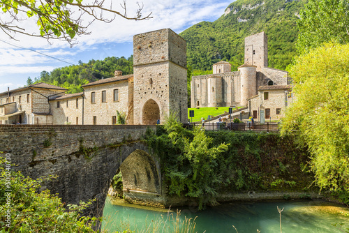 San Vittore alle Chiuse. Roman Catholic abbey and church. The edifice is known from the year 1011. Ponte Romano. Roman bridge over a small river. Italy. photo