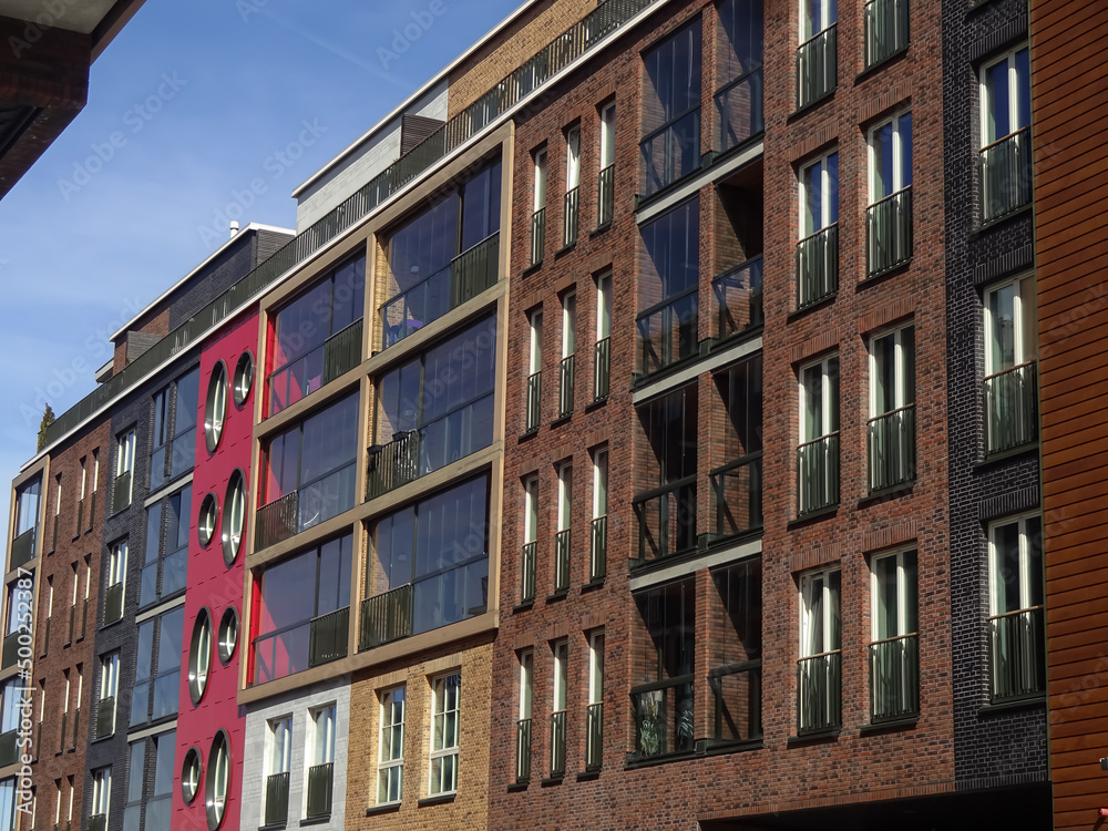 Naklejka premium Close up of new modern building brick facade with red, brown blocks in Noblessner district. Tallinn, Estonia, Europe. April 2022