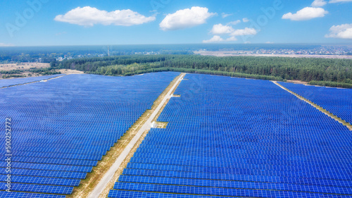 aerial view of solar panels on green lawn. drone shot, bird's eye