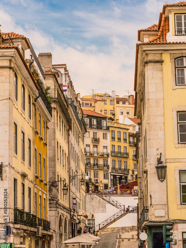 A view up a side street leading from the Central Square in the Alfama distict in the city of Lisbon on a spring day