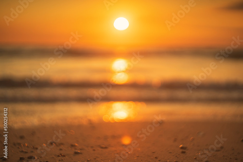 Blur tropical beach with smooth wave and sunset sky abstract background. Copy space of business summer vacation and travel adventure concept.