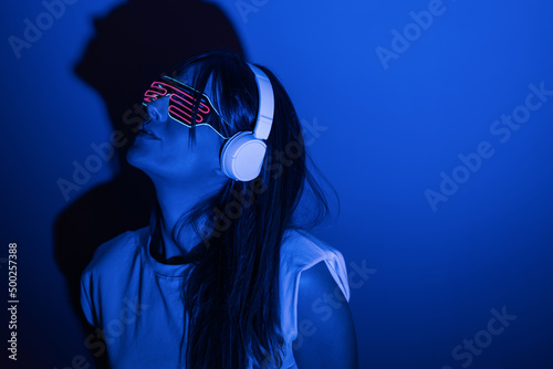 Woman in sunglasses listening to music photo