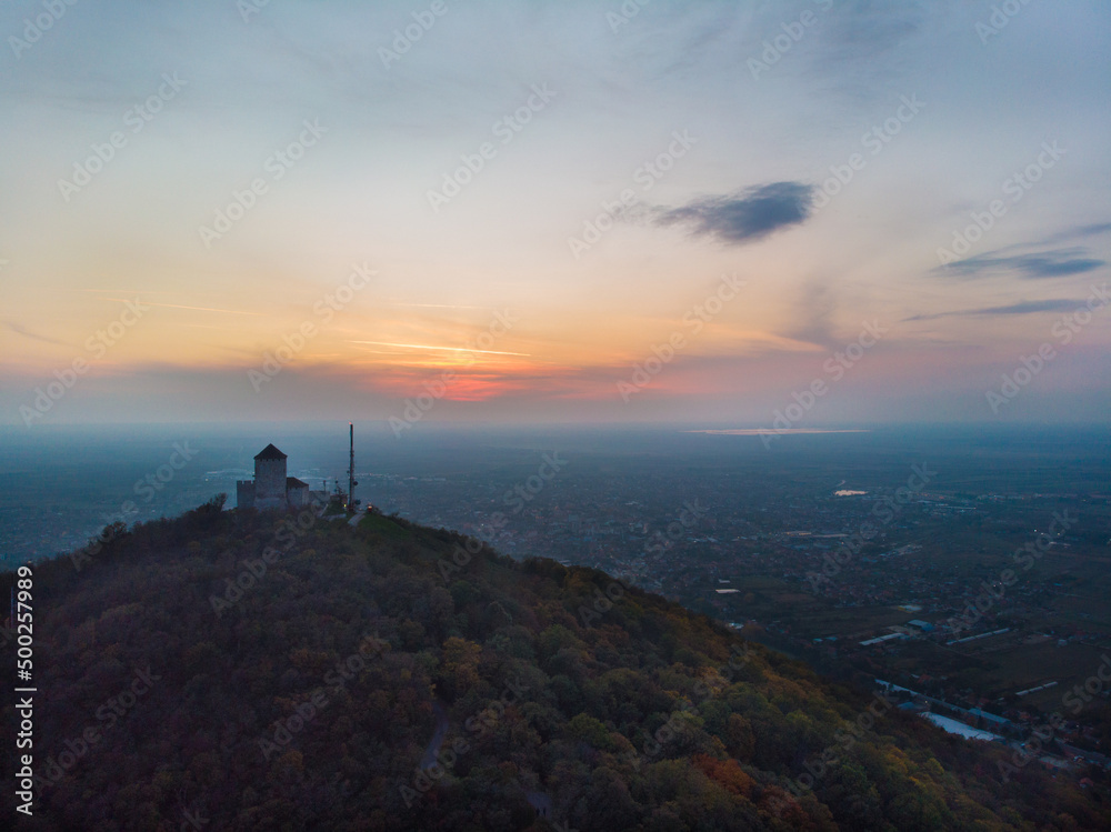 Fortress over the town of Vršac and the sunset. Aerial photography.