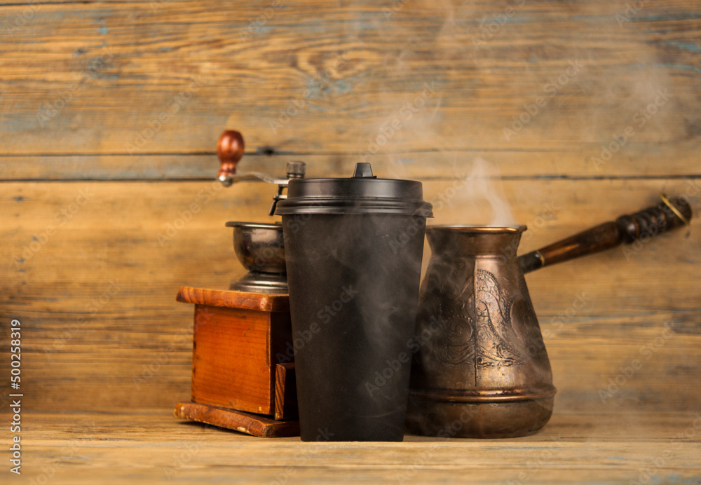 cup of coffee, coffee beans, turk, coffee grinder on a wooden background cup of coffee, coffee beans, turk, coffee grinder on a wooden background