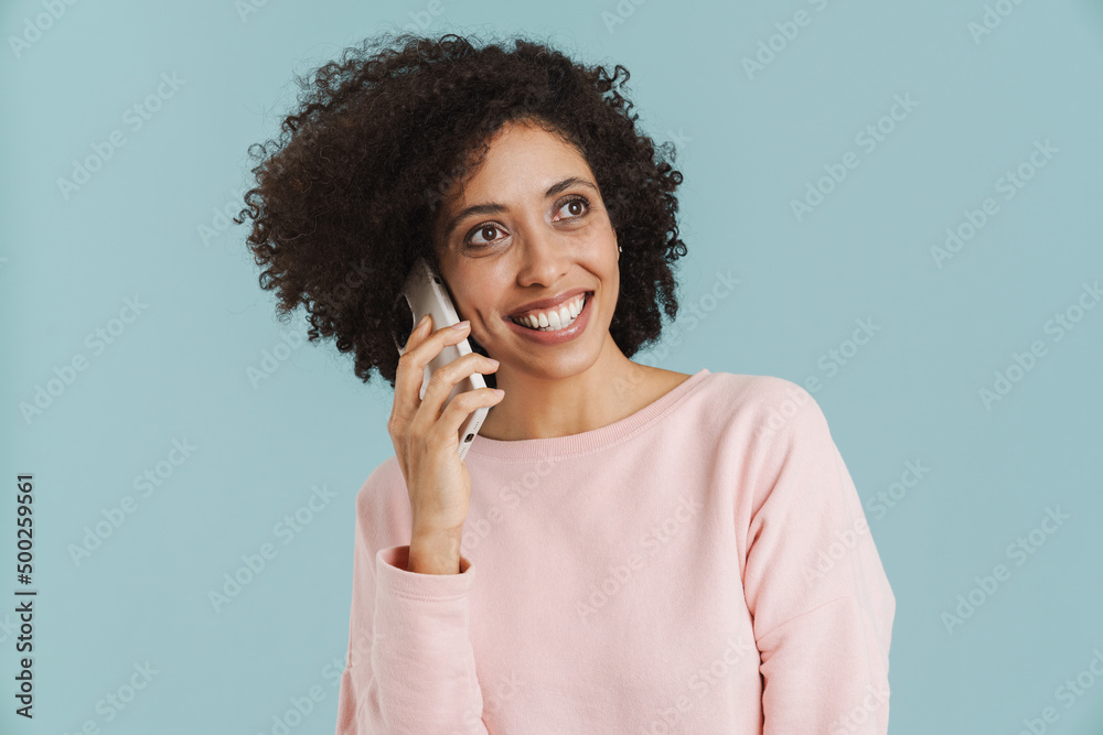 Young hispanic woman smiling while talking on mobile phone Young hispanic woman smiling while talking on mobile phone