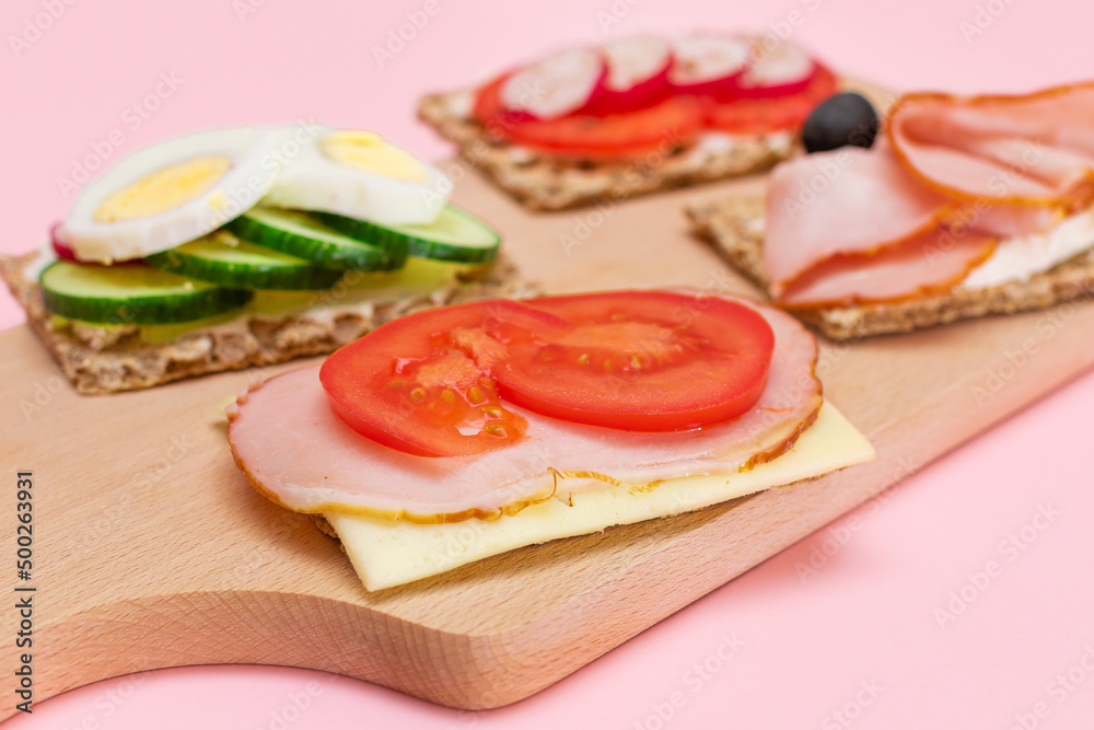 Different Whole Grain Crispbread with Ham, Tomato, Radish, Cucumber and Cheese. Easy Breakfast. Diet Food. Quick and Healthy Sandwiches. Crispbread with Tasty Filling. Healthy Dietary Snack