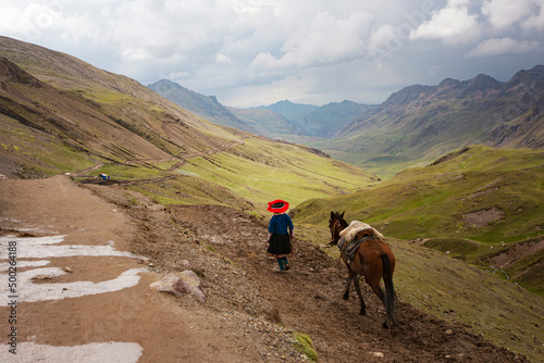 Peruvian woman with a horse at Vinicunca Rainbow mountain  Cusco province  Peru