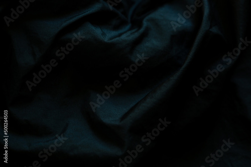 Black wrinkled fabric surface,Close up of wrinkled black color fabric bed sheet texture background