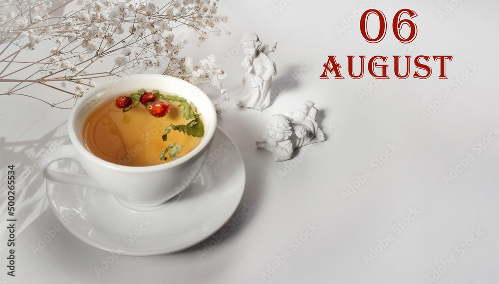 calendar date on light background with a porcelain cup of green tea, white gypsophila and angels with copy space. August 6 is the sixth day of the month calendar date on light background with a porcelain cup of green tea, white gypsophila and angels with copy space. August 6 is the sixth day of the month