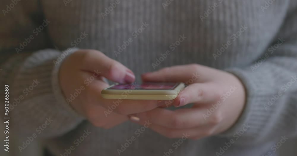 Close up of a young woman with smartphone, happy girl using mobile phone standing up. Concept of online addiction, social media, sms messages, sex dating, internet. High quality 4k footage Close up of a young woman with smartphone, happy girl using mobile phone standing up. Concept of online addiction, social media, sms messages, sex dating, internet. High quality 4k footage