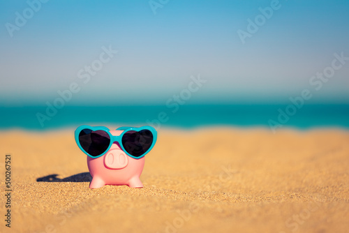 Piggybank on the beach in summer