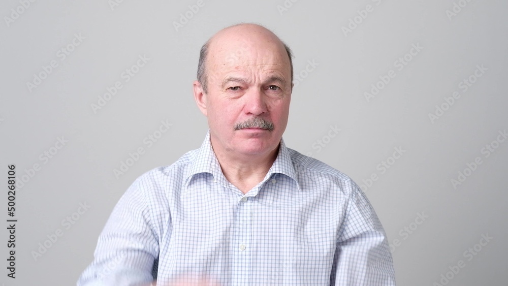 Not sure. Mature adult in shirt having a doubt Not sure. Mature adult in shirt having a doubt