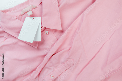 price tag hang over pink shirt close up view - Image