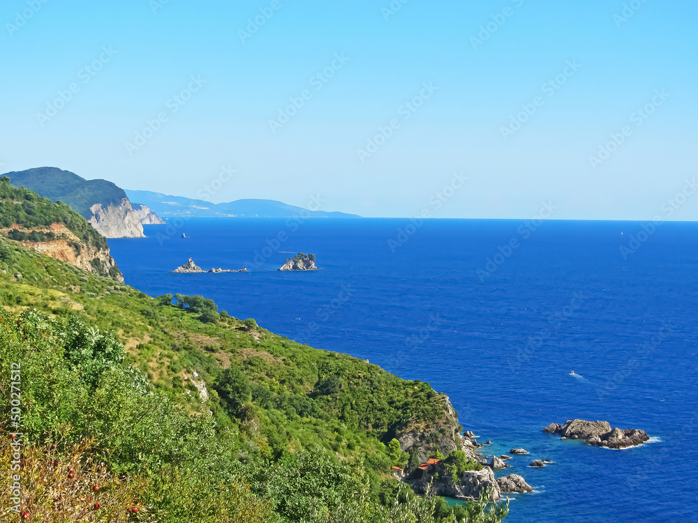 The coast in Montenegro. Rocky coast with beaches of the Adriatic Sea. On a sunny day. Beautiful view photo wallpaper. Sea shore. Wild nature sea ocean