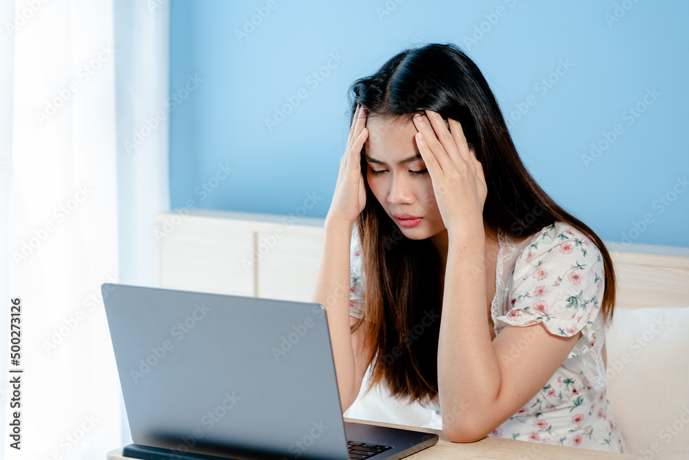 Asian woman shopping online on laptop He put his hands over his head and showed a worried expression because he couldn't buy the product in time. on bed in the bedroom online shopping ideas Asian woman shopping online on laptop He put his hands over his head and showed a worried expression because he couldn't buy the product in time. on bed in the bedroom online shopping ideas