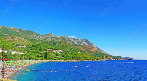 Fototapeta Naklejka Na Ścianę i Meble -  The coast in Montenegro. Rocky coast with beaches of the Adriatic Sea. On a sunny day. Beautiful view photo wallpaper. Sea shore. Wild nature sea ocean