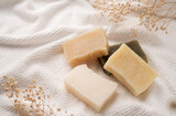 Handmade soap bars on white towel top view with copy space