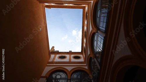 Looking a bright orange walls of a patio of , Real Alcazar, Seville, Andalusia, Spain photo