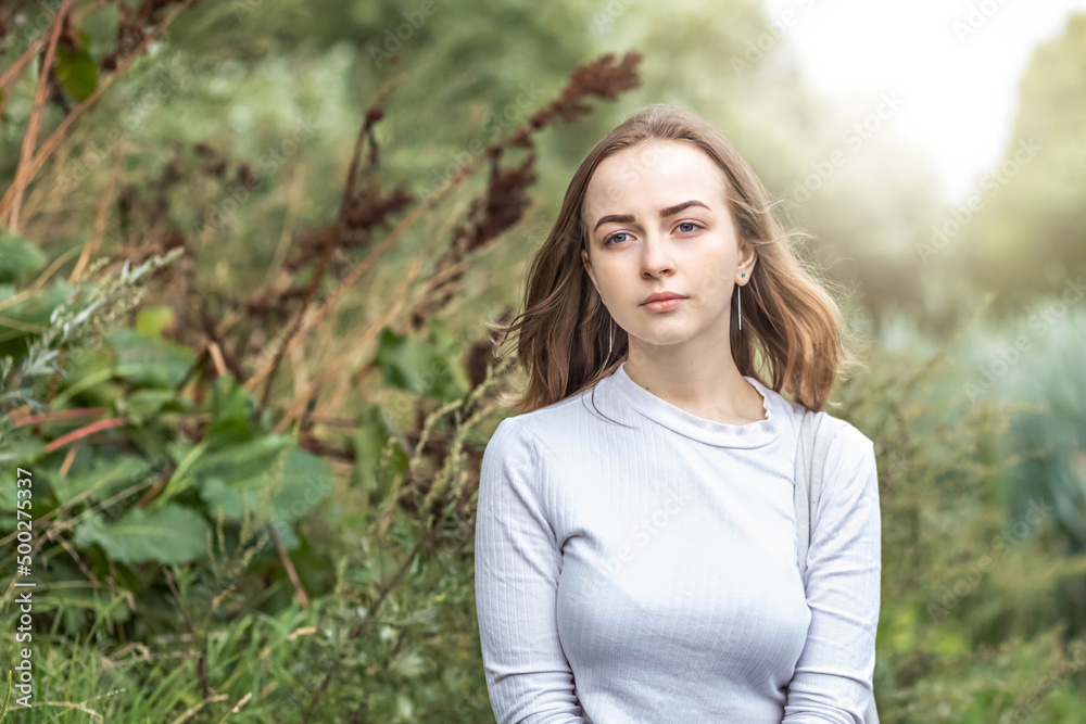 Portrait of a young teenager girl in the park. Spring. Portrait of a young teenager girl in the park. Spring.
