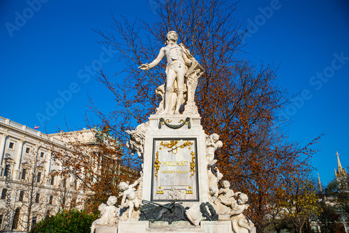 Marble Statue dedicated to the famous compositor and musician Wolfgang Amadeus Mozart on a sunny day in Burggarten garden in Vienna, Austria