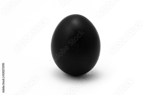 Black egg isolated on a white background. The concept of coloring eggs for Easter. Standing alone egg