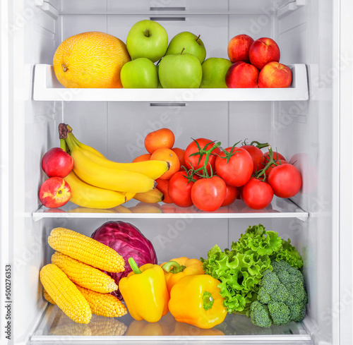 Fototapeta Naklejka Na Ścianę i Meble -  Open fridge full of vegetables and fruits