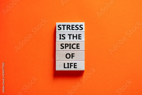 Stress spice of life symbol. Concept words Stress is the spice of life on wooden blocks. Beautiful orange table orange background. Business motivational stress spice of life concept. Copy space. photo