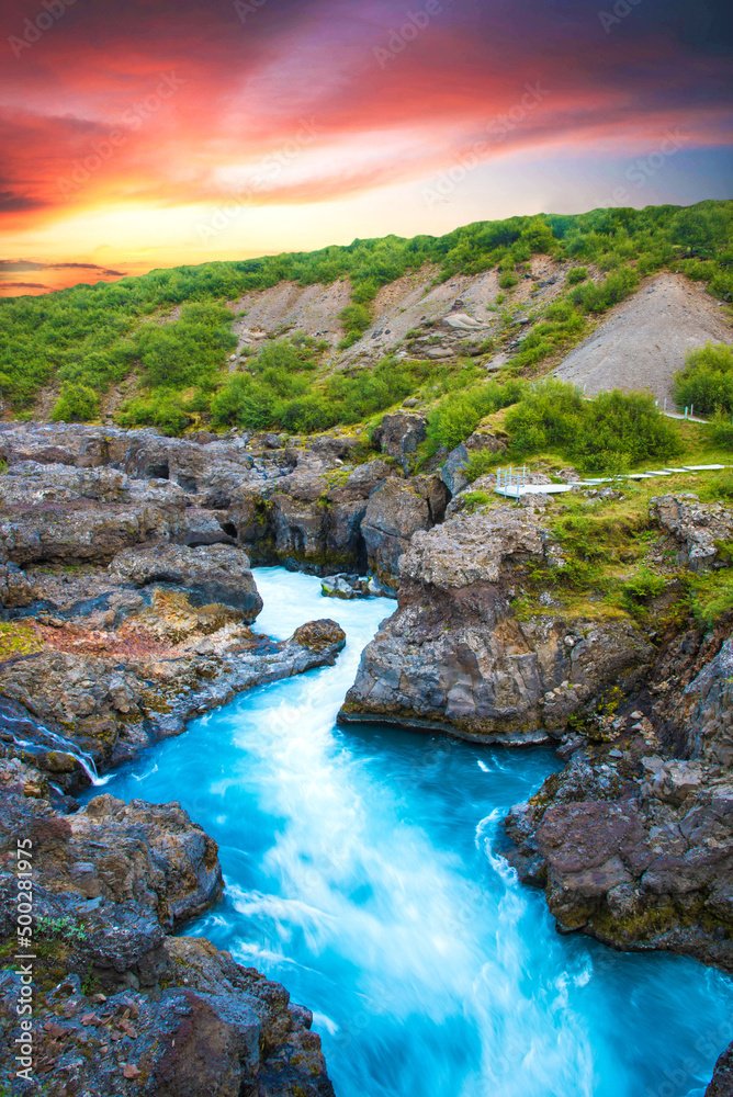 Beautiful mystical landscape with river in canyon Kolugljufur  between the rocks in Iceland at red dawn. Exotic countries. Amazing places.