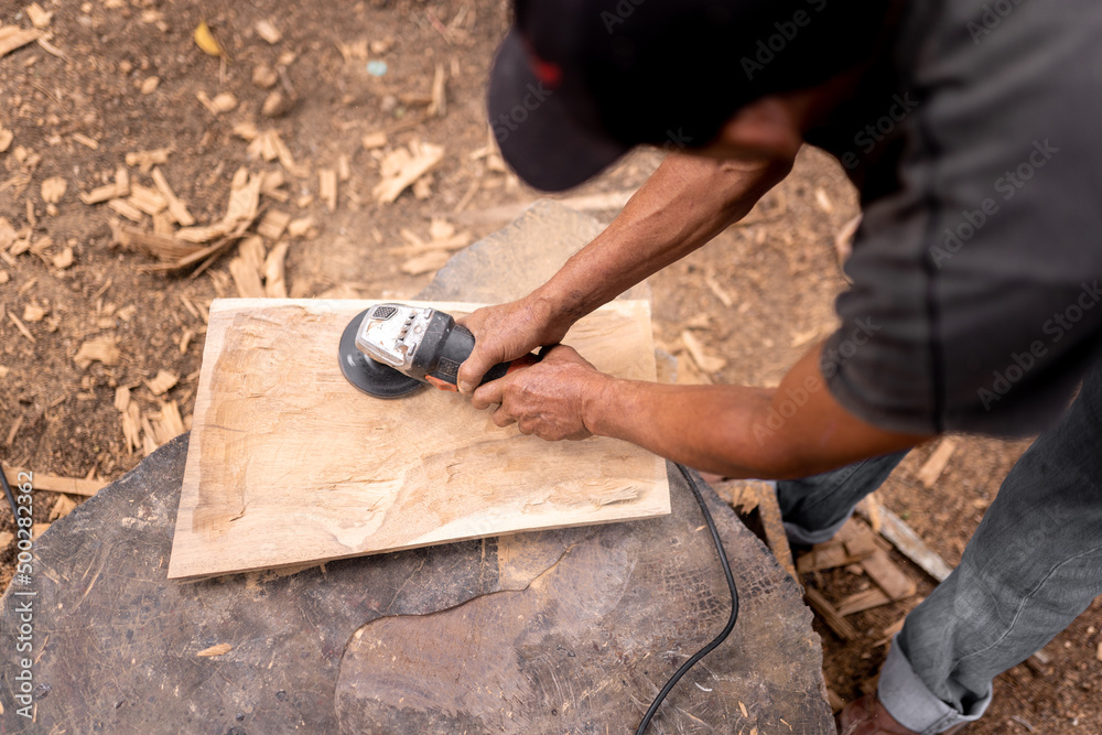 Anonymous man polishing wooden table Anonymous man polishing wooden table