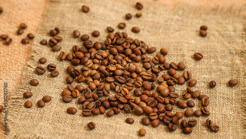 A cup of coffee and grains on a white background.
