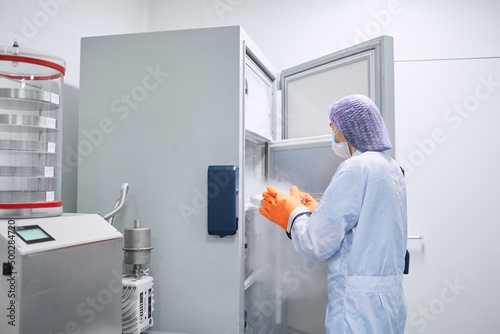 Scientists work in the laboratory. Remove the biomaterial from the freezer