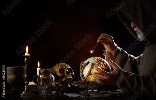 Medieval magician in his magic room