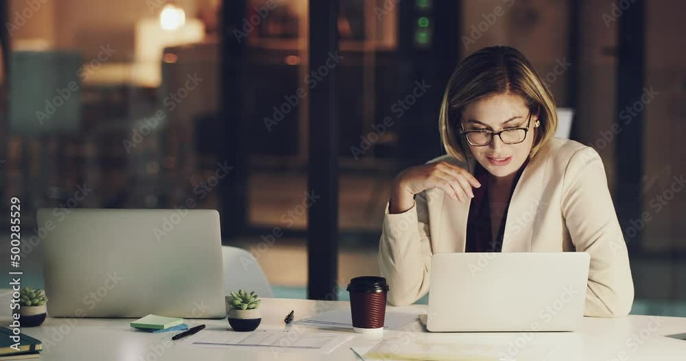 Time just flies by when shes working. 4k footage of a happy businesswoman working on her laptop in the office late at night. Time just flies by when shes working. 4k footage of a happy businesswoman working on her laptop in the office late at night.