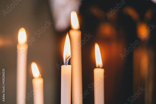 Burning candles in the dark church, mourning, selective focus