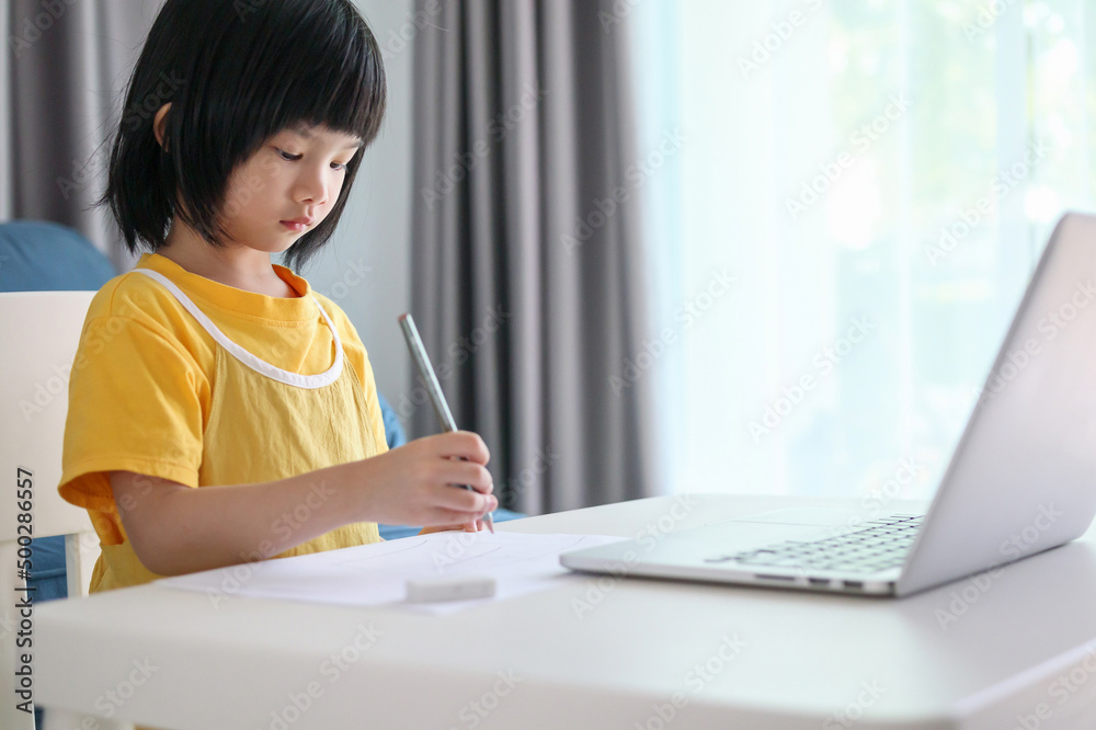 little asian girl student study online using laptop computer at home little asian girl student study online using laptop computer at home