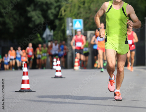athletic marathon during the foot race in the city with sportswear