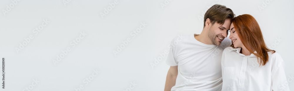 Young couple with closed eyes smiling isolated on white, banner.