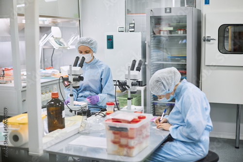 Women work in the lab. Conducts experiments on vaccines.