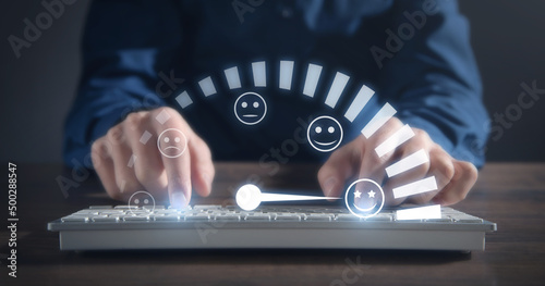 Male hand typing in computer keyboard. Customer emotions satisfaction meter