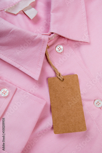 price tag hang over pink shirt close up view - Image