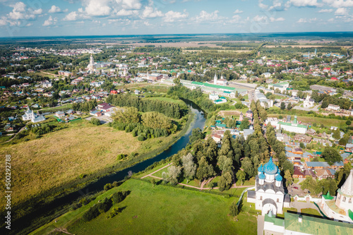 Aerial view panorama of cityscape of the Suzdal Kremlin on a bend of the Kamenka river. Russia, Vladimir region, Golden Ring of Russia © Alexey Oblov