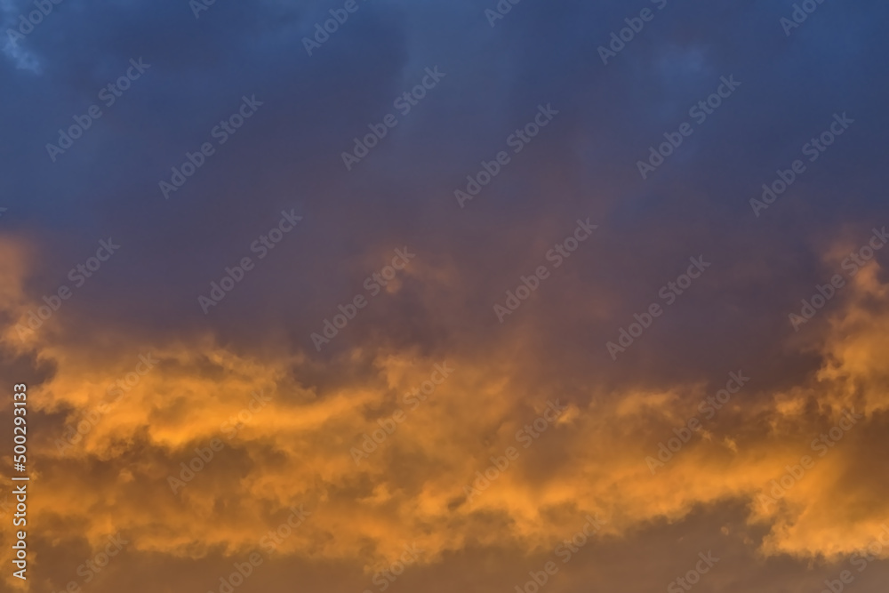 Colorful cloudy evenig sky in blue, orange and grey