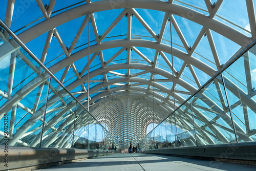 Peace Bridge in Tbilisi, Georgia. Pedestrian bridge of modern design that crosses the Kura River. Constructed of curved steel and glass © JoseMaria