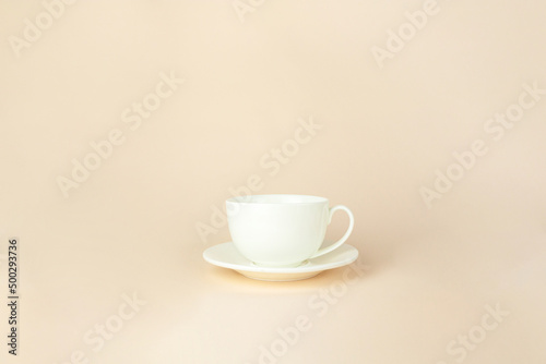 Porcelain cup flying with marshmallows on a pastel background. Gravity, levitation concept.
